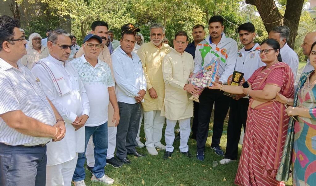 Athletes sought blessings from Minister Rajesh Nagar after winning medals.